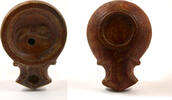 Roman A Roman terracotta volute oil lamp. -